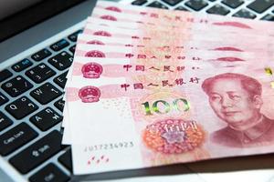 Yuan or RMB, Chinese Currency on laptop's keyboard photo