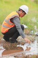 Environmental engineers work at water source to check for contaminants  in water sources and analysing water test results for reuse.World environment day concept. photo