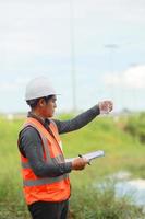 Environmental engineers work at water source to check for contaminants  in water sources and analysing water test results for reuse.World environment day concept. photo