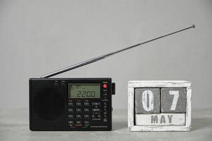 May 07, wooden calendar and radio gray background.Concept for Radio day. photo