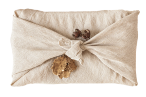 Beige cloth wrapped a gift held isolated on a transparent background png