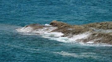 Waves breaking near a rocky shore video