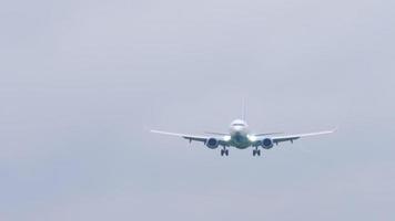 Airplane approaching before landing. Airplane landing in gray rainy weather video