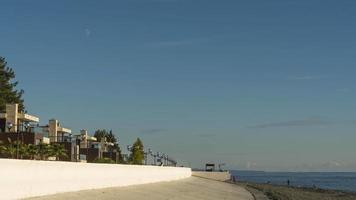 Tourists walking along the embankment in the city of Sochi, timelapse video