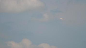 AMSTERDAM, THE NETHERLANDS JULY 26, 2017 - Emirates Airbus A380 fly in the cloudy sky at a long distance. Airliner flew into the cloud. Tourism and travel concept video