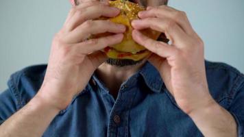 Man eats juicy hamburger video