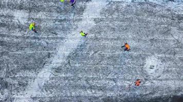 View from the height on unrecognizable people playing hockey in the winter outdoors video