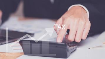 Business people planning annual tax deduction, tax rate calculation, business financial budget, Calculate business balance to reduce taxes ,Individual income tax ,Property and land tax management photo