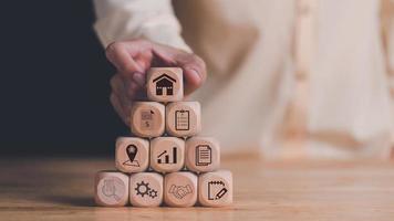 man holding wooden block,Investment loan approval concepts to build residential homes, real estate business, ,Finding a location to invest in real estate,Investment in real estate, houses and land photo