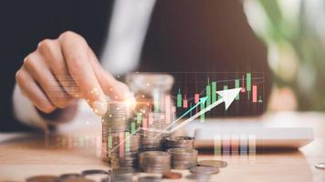 Businessman holding a stack of coins,high return investment,profit growth,Money and Investment Strategy,business investment analysis,financial success,development of increased revenues of the business photo