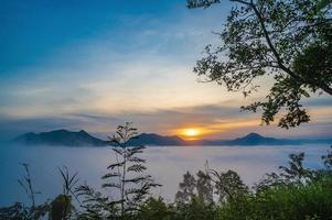 Beautiful sunrise with sea of fog in the early moring at phu thok chiang khan district leoi city thailand.Chiang Khan is an old town and a very popular destination for Thai tourists photo