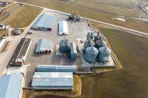 aerial panoramic view on agro-industrial complex with silos and grain drying line photo