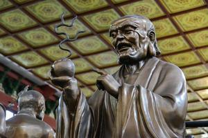 Hall with statues at Lingyin Temple, Hangzhou, Zhe jiang, China Focused at left statue photo