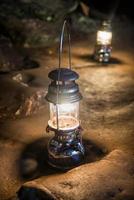 The old antique storm lantern in a cave photo