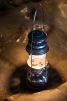 The old antique storm lantern in a cave photo