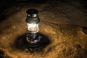 The old antique storm lantern in a cave photo