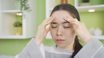 Asian young woman with severe headache has migraine. Asian young woman with migraine has severe and prolonged headache. video