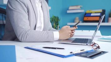 Close-up of angry businessman reacting to bad news. Businessman working in the office gets angry at the bad news notification on his phone and throws the phone. video