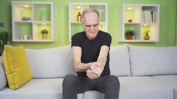 Arm pain, old man. Elderly man with arm pain touching his arms with his hand. video