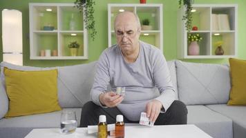 Grumpy old man using over-the-counter drugs by heart. The old man who uses over-the-counter and rote medicines at home without caring. video