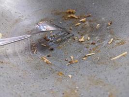 Empty bowl after dinner with fork and remaining spaghetti. The photo is suitable to use for food poster and food content media.