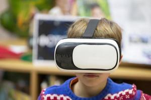 Child in virtual glasses. The boy in 3D glasses. photo