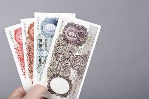 Old Argentine peso  in the hand on a gray background photo