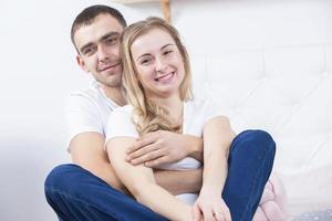 Portrait of a beautiful couple in jeans.Young man and woman hugging. Lovers photo