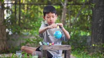 Concentrated asian boy coloring solar system toys, sensory activity, learning tools at home. video