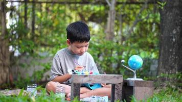 Concentrated asian boy coloring solar system toys, sensory activity, learning tools at home. video