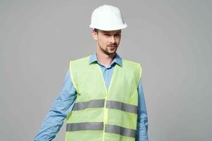 man reflective vest blueprints builder light background photo