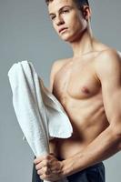 portrait of a sports guy naked torso towel in hand posing photo