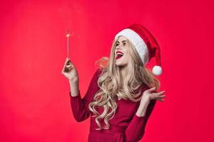 merry woman santa hats christmas holiday fashion red background photo