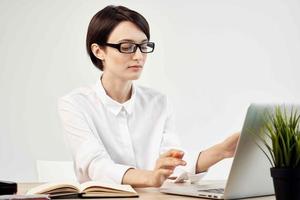 Businesswoman at the desk with glasses self-confidence isolated background photo