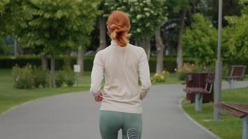 in esecuzione anoressico caucasico femmina nel il parco, Salute i problemi. video