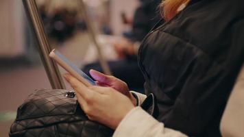 Passenger using technology phone in subway for travel. video