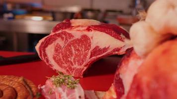 Zoom out beef ribeye steak surrounded by diffferent meat handmade products. video