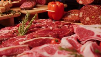 Close up delicious meat table layout raw steaks and sausages. video