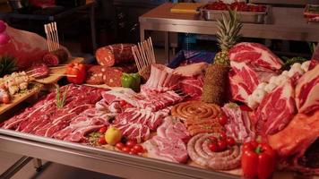 Meat products on display for sale on butchers table. video