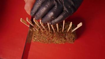 Top view of cook slicing a rolled beef seasoned with spices. video