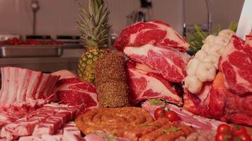 Seasoned roulade and barbeque skewers along with raw meat sclices. video