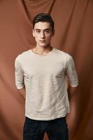 Man in white sweater fashionable hairstyle Studio fabric background lifestyle model photo