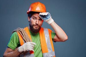 Man in orange paint hard work Professional blue background photo