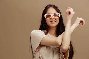 Brunette in sunglasses t-shirt posing modern styles isolated background photo