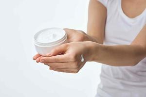 cream in female hands moisturizing dermatology skin care photo