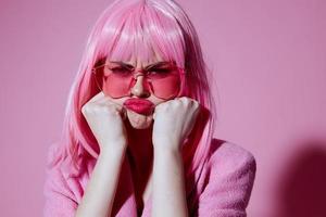 Pretty young female bright makeup pink hair glamor stylish glasses pink background unaltered photo