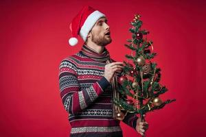 cute man in christmas clothes christmas tree toys lifestyle photo