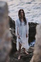 Attractive woman in white dress at the sea beach nature photo