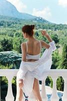 slender woman in lingerie on the balcony beautiful view from the window Summer day photo