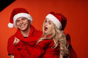 Man and woman in santa hats fun new year holiday isolated background photo